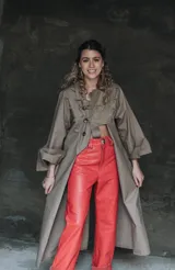 Pantalón de cuero rojo, de tiro alto y corte recto, con cierre frontal y bolsillos funcionales.