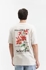 Remera de manga corta color crudo, corte oversize, con estampa en la espalda que incluye flores rojas, texto con el nombre de la marca y la frase 'The Art Society'.