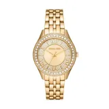 Reloj de pulsera Michael Kors modelo Harlowe, con caja y malla de acero inoxidable en tono dorado. Presenta una esfera dorada con acabado sunray, números romanos y un bisel decorado con cristales brillantes.