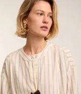 Vestido chemise midi de corte camisero, con escote en pico y botonadura frontal parcial. Presenta mangas 3/4 y un diseño de rayas verticales en tonos claros.