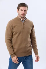 Buzo tejido de lana con cuello alto y medio cierre metálico frontal. Presenta puños y ruedo acanalados, con logo bordado en el pecho.