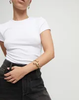 Pulsera rígida dorada con tres bolas en aleación de metales bañadas en oro 18k.