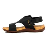 Sandalia plana de mujer color negro, con diseño cerrado en la parte delantera que cubre los dedos y parte del empeine con tiras cruzadas. Posee una pulsera ajustable con velcro en el tobillo. La suela es de goma marrón con plantilla color corcho.