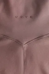 Leggings de yoga acampanados de tiro alto en tejido funcional, con cintura ancha y detalle de nudo en el frente.