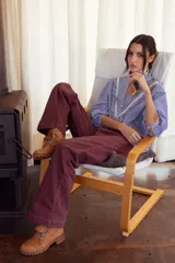Pantalón de jean color bordó, de corte recto y tiro medio, con costuras reforzadas y cierre frontal.