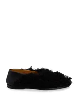 Zapato bajo negro de cuero con detalle de piel sintética rizada en la parte delantera.