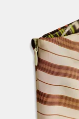 Top de escote asimétrico (un solo hombro) con manga sisa. Presenta un estampado tipo patchwork con bloques de rayas horizontales y un sector con patrón a cuadros, en tonos marrones, beige y verde lima.