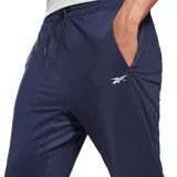 Pantalón deportivo Reebok de hombre, color azul marino, corte entallado, con cintura elástica ajustable con cordón y logo de la marca estampado en blanco en la pierna izquierda.