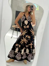 Vestido largo de algodón italiano con estampado floral, escote en V, espalda descubierta con elástico y tiras para atar al cuello.