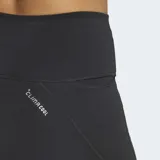 Short deportivo Adidas de tiro alto, confeccionado en tejido técnico negro con tecnología Climacool para absorción de sudor. Presenta ajuste ceñido al cuerpo, cintura elástica con cordón de ajuste externo y bolsillos laterales en los muslos.