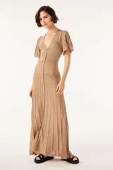 Vestido largo dorado de punto con mangas cortas con volantes, escote en V y cierre frontal con botones.