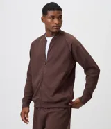 Campera bomber de fleece color marrón, con cierre frontal, cuello tipo tirilla, mangas largas y bolsillos laterales con cierre.