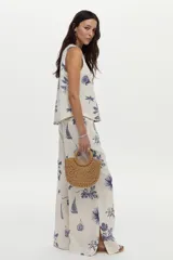 Musculosa de lino y viscosa, color crudo con estampado azul de barcos, libélulas, higos y hojas. Presenta escote redondo.