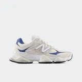 Championes New Balance modelo 9060, de estilo chunky en tonos blanco off-white, beige y detalles en azul vibrante. Presentan una entresuela esculpida gruesa con amortiguación y la característica "N" lateral en relieve.