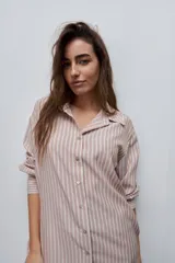 Camisa de manga larga con diseño de rayas verticales blancas y verdes, calce relajado, cuello clásico y botonadura frontal con botones perlados.