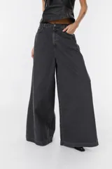 Jean de corte wide leg en color bordó, confeccionado en denim de algodón. Presenta tiro medio, bolsillos traseros amplios y una silueta holgada y fluida.