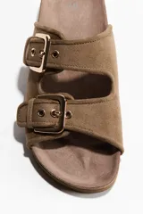 Sandalias color marrón topo, con dos tiras anchas ajustables mediante hebillas metálicas doradas. Presentan plantilla anatómica y suela con borde de corcho.