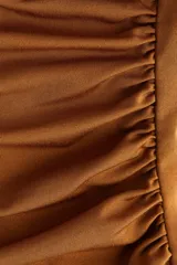 Vestido mini de manga larga en punto elástico con escote cruzado en V. Modelo de corte ajustado con frunces en hombros y laterales para crear un efecto drapeado.