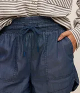 Short runner de jeans color azul, con cintura elástica ajustable con lazo, bolsillos grandes aplicados en el frente y bajo redondeado.