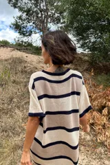 Vestido de tejido artesanal con diseño de rayas horizontales en tonos beige y azul marino, de corte holgado y manga corta.