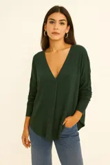 Sweater verde oscuro de lanilla con escote en V profundo y mangas largas.