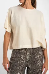 Remera color crema con brillo, de corte amplio y mangas cortas.