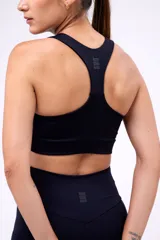 Top deportivo negro con breteles anchos y espalda deportiva.