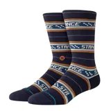 Medias de caña alta Stance Flowrider color azul marino, con diseño de bandas horizontales estampadas, líneas finas en tonos naranjas y morados, y el nombre de la marca repetido en el cuerpo.