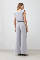 Pantalón ancho de lino color gris melange con tajos laterales.