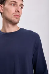 Remera básica de manga larga blanca, cuello redondo y corte clásico.