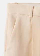 Pantalón wide leg de tiro bajo color beige, con trabillas y dos bolsillos laterales.