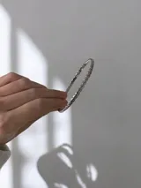 Pulsera esclava rígida con diseño trenzado, fabricada en acero quirúrgico con acabado brillante.