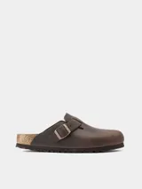 Zuecos Birkenstock Boston de cuero engrasado color marrón oscuro, con plantilla anatómica de corcho y látex, y hebilla metálica ajustable.