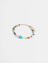 Pulsera elástica con cuentas de colores, perlas de río y un dije de ojo turco.