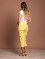Pantalón capri blanco de gabardina elastizada. Pretina ancha elastizada, delantera con bolsillos simulados y trasera con bolsillos aplicados.