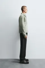 Pantalón de jean corte slim fit, color gris con efecto lavado. Presenta diseño de cinco bolsillos, cierre frontal con cremallera y botón, y tejido elástico.