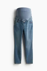 Jean tobillero de cinco bolsillos en denim levemente elástico, con piernas ajustadas y sección ancha de punto en la cintura para maternidad.