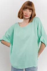 Blusa de lino color verde oliva, de corte amplio y relajado, con escote redondo y mangas 3/4 remangadas.