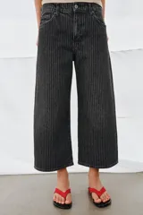 Jeans de tiro medio con diseño culotte y pierna ancha. Presenta un estampado de rayas verticales a contraste, cierre frontal con cremallera y botón, trabillas en la cintura y cinco bolsillos.