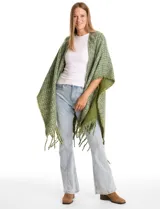 Ruana de tejido tweed con hilos de lurex, diseño abierto con terminación de flecos en los bordes.