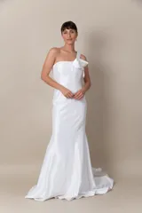Vestido largo de fiesta color blanco, confeccionado en tafeta. Diseño asimétrico con un solo bretel que se extiende en un volado de organza desde el hombro hasta la espalda.