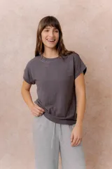 Remera básica de corte relajado, color gris oscuro, con cuello redondo y mangas cortas de hombro caído con terminación doblada.