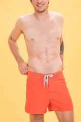 Short de baño naranja con cintura fija, bolsillo lateral con cierre, cordón bicolor y suspensor de malla fina.