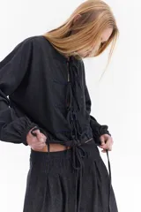 Blusa de denim liviano, estilo oriental con cierre frontal de lazos y costuras a contratono.