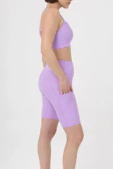 Calza corta de lycra verde militar, tiro alto, corte biker y bolsillos laterales.