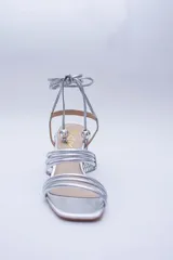 Sandalias doradas con taco cuadrado y tiras finas que se atan al tobillo. Capellada, forro y plantilla 100% de cuero.