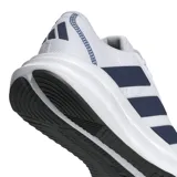 Championes de running Adidas Galaxy 7, color blanco con las tres tiras laterales en azul marino. Presentan una estructura de malla transpirable y entresuela con tecnología Cloudfoam para mayor amortiguación.