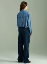 Camisa negra de algodón con mangas largas, cuello camisero y detalles de ribetes estampados a cuadros en los hombros, puños y aberturas de botones.