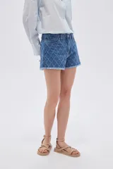 Short de jean azul con tiro alto, calce recto, bolsillos, diseño acolchado con rombos pespuntados y terminación desmechada en las piernas.