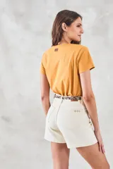 Remera de algodón color mostaza, de manga corta y escote en V con detalle metalizado.